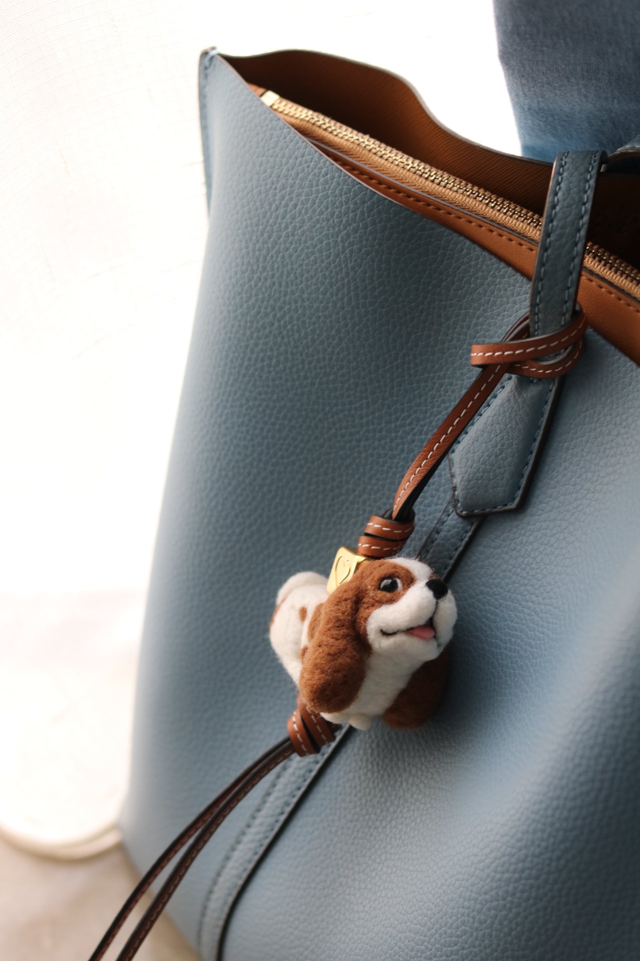 Custom felt dog charm hanging on bag