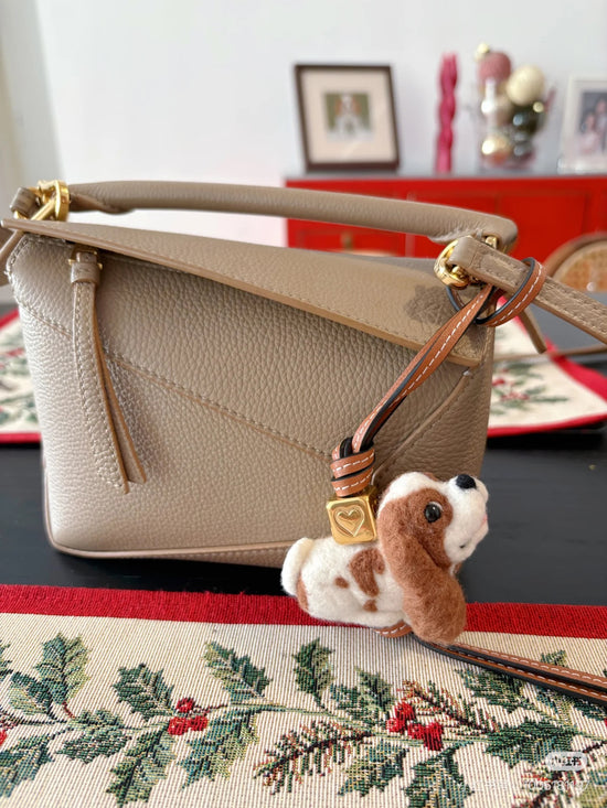 Custom felt dog charm hanging on bag