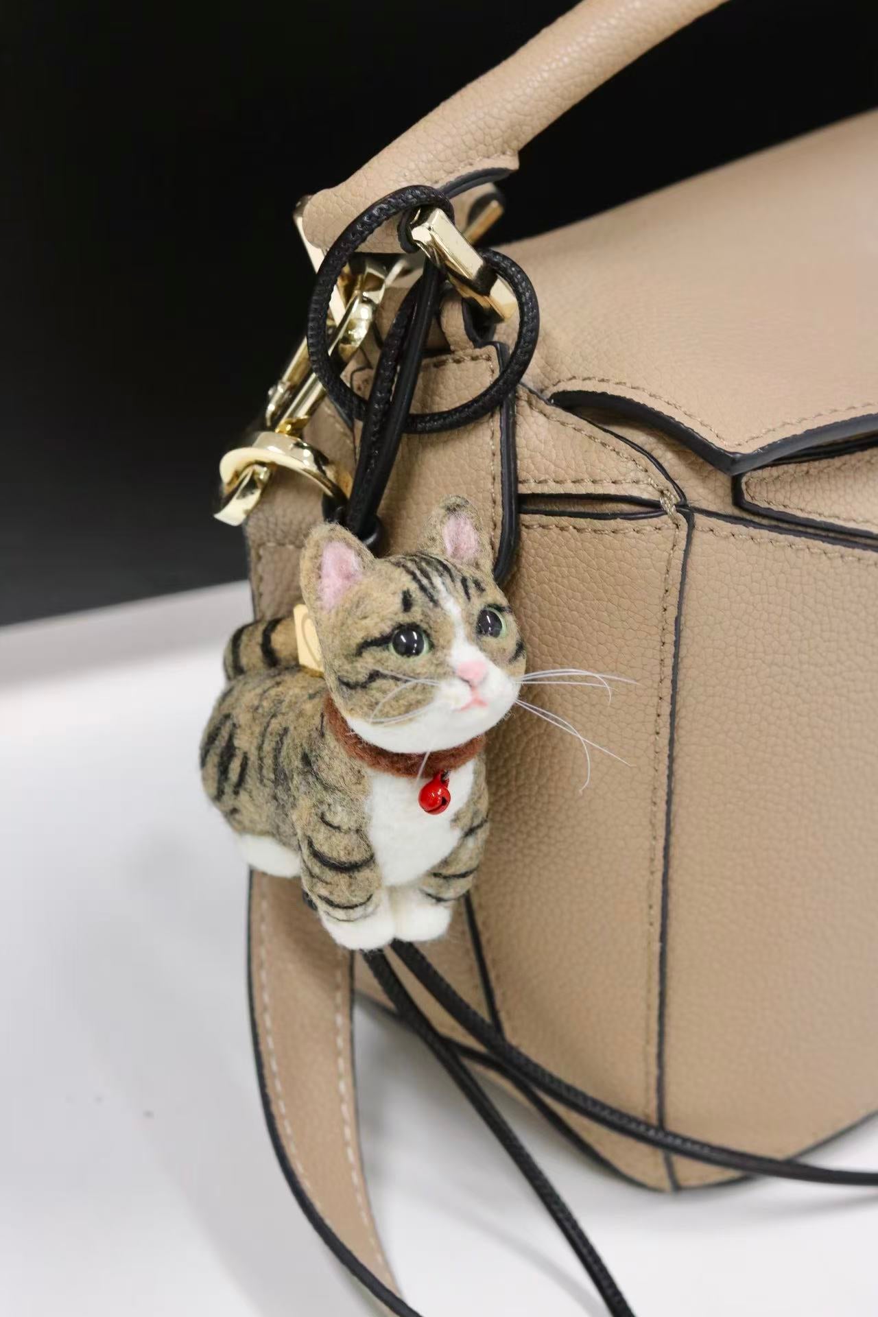 Custom felt cat ornament hanging on bag as charm